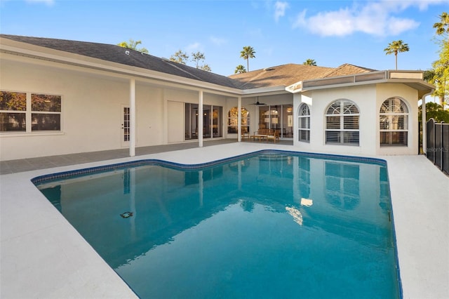 outdoor pool with a patio and ceiling fan