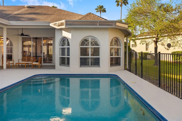 view of pool featuring a fenced in pool, fence, a ceiling fan, and a patio