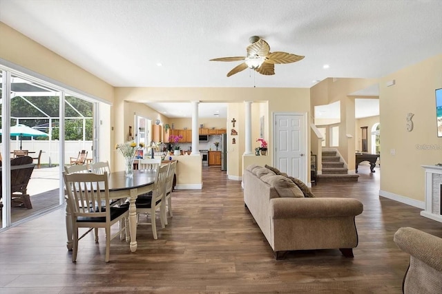 dining area with ceiling fan, a textured ceiling, baseboards, stairs, and dark wood finished floors