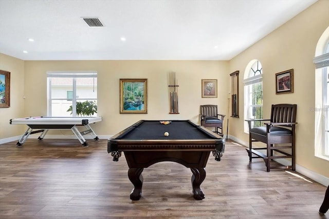 recreation room featuring baseboards, visible vents, and wood finished floors