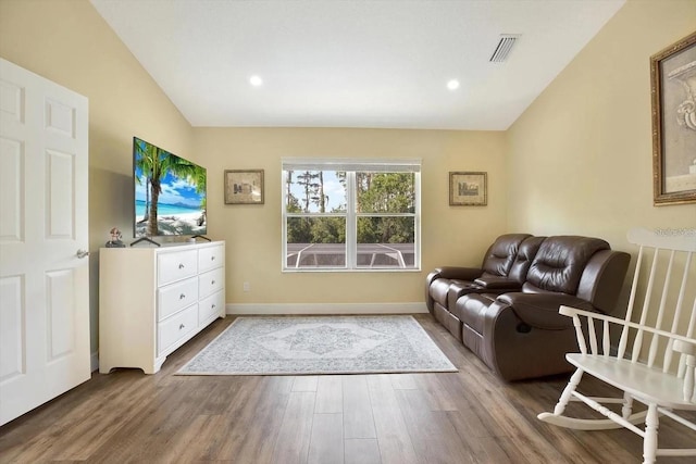 living room with lofted ceiling, recessed lighting, visible vents, wood finished floors, and baseboards