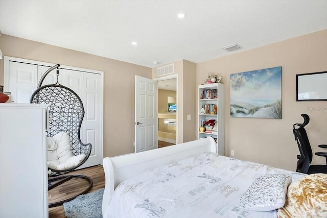 bedroom with recessed lighting, a closet, visible vents, and wood finished floors