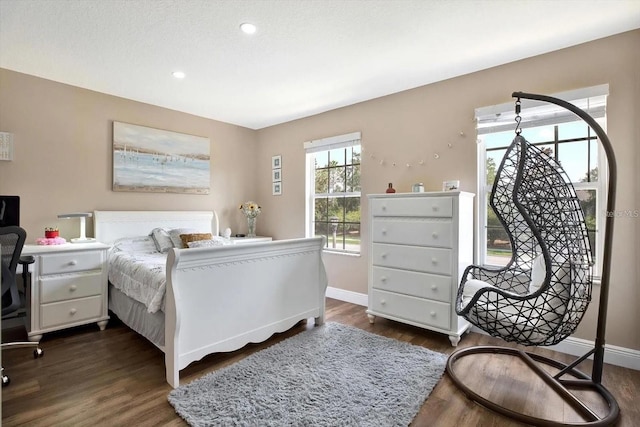 bedroom featuring recessed lighting, dark wood-style flooring, and baseboards