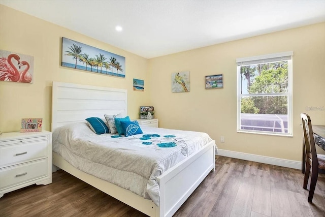 bedroom with dark wood-type flooring, recessed lighting, and baseboards