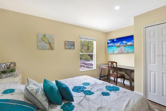 bedroom featuring baseboards, a closet, and wood finished floors