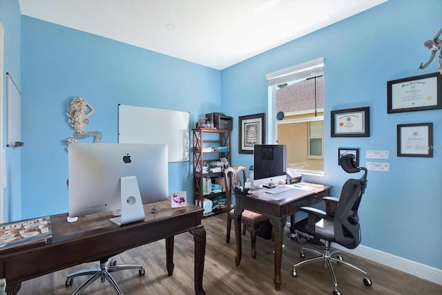 office area featuring baseboards and wood finished floors