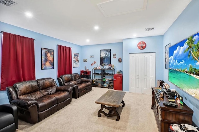 carpeted living room featuring attic access, visible vents, and recessed lighting