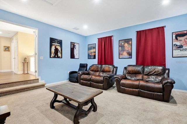 living room featuring carpet flooring, visible vents, and baseboards