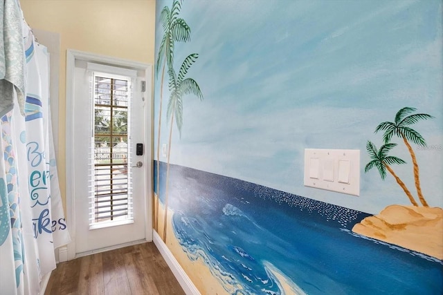 doorway to outside featuring wood finished floors and a wealth of natural light