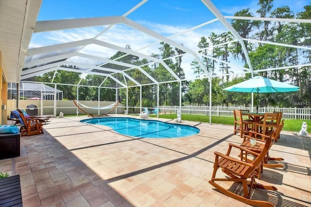 view of pool featuring a patio area, a fenced backyard, glass enclosure, and a fenced in pool