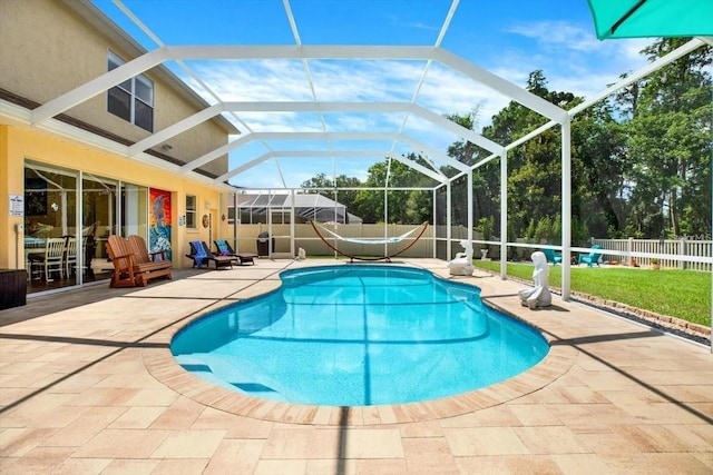 view of swimming pool with a patio area, a fenced backyard, a fenced in pool, and a lanai