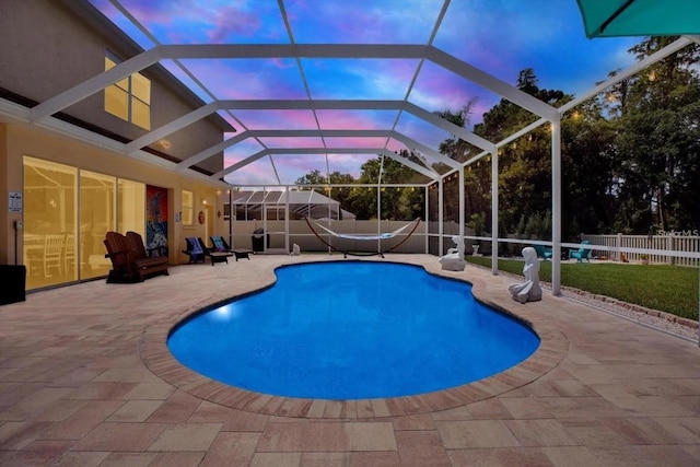 pool at dusk with a fenced in pool, a patio area, and a fenced backyard