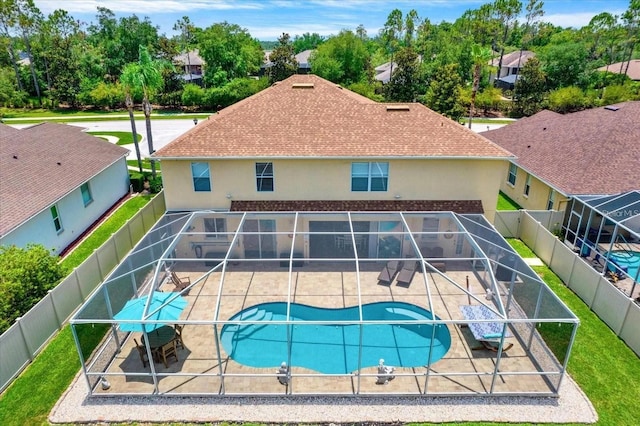 view of pool with a patio area, a fenced backyard, a fenced in pool, and a lanai