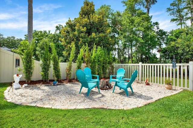 exterior space with a fenced backyard and a fire pit