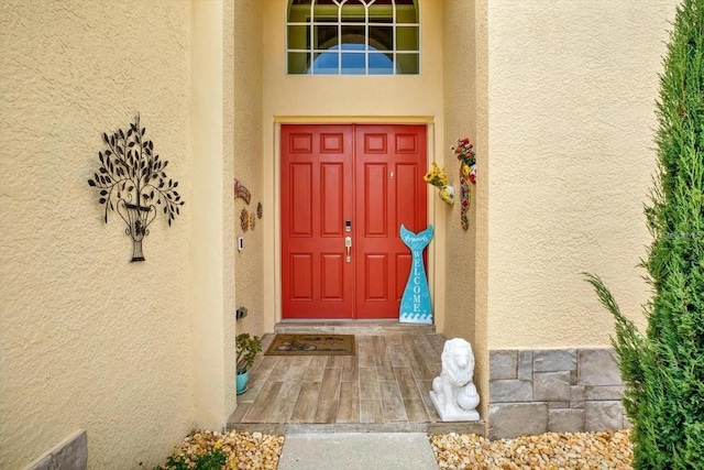 property entrance with stucco siding