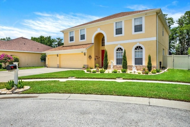 view of front facade with stucco siding, concrete driveway, fence, a garage, and a front lawn