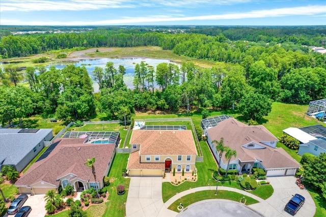 aerial view with a forest view and a water view