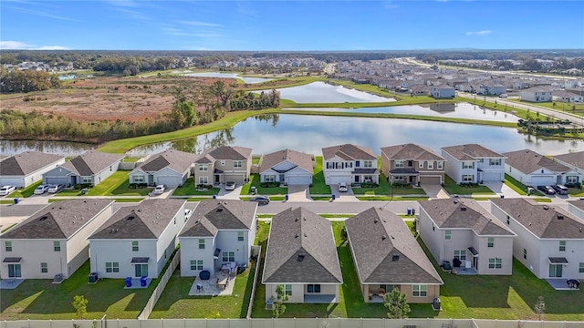 bird's eye view with a water view and a residential view