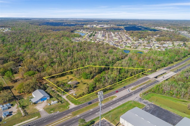 birds eye view of property with a wooded view