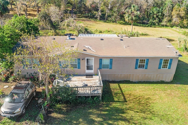 back of house featuring a deck and a lawn