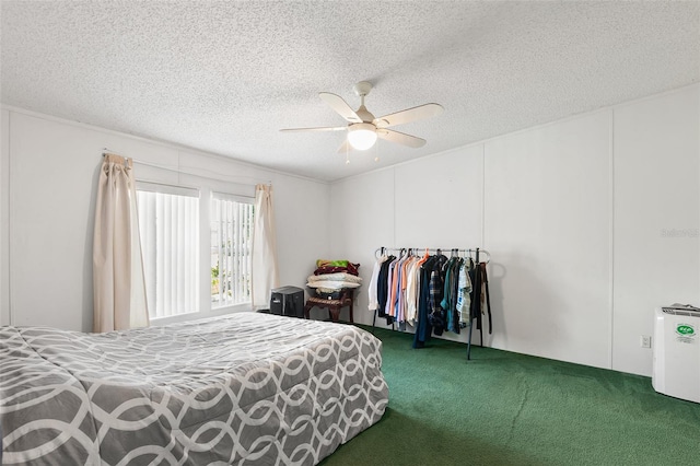 bedroom featuring carpet floors, ceiling fan, and a textured ceiling