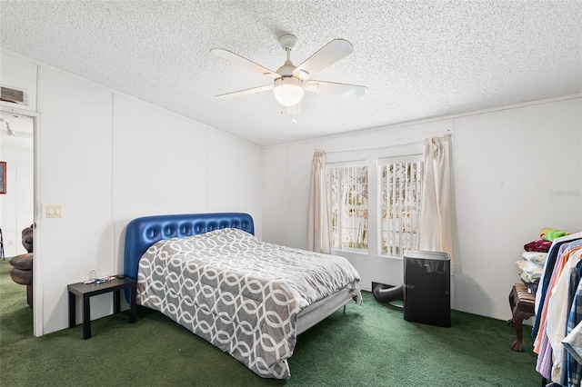 carpeted bedroom with ceiling fan, visible vents, and a textured ceiling