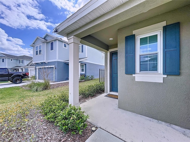 property entrance featuring a residential view and stucco siding