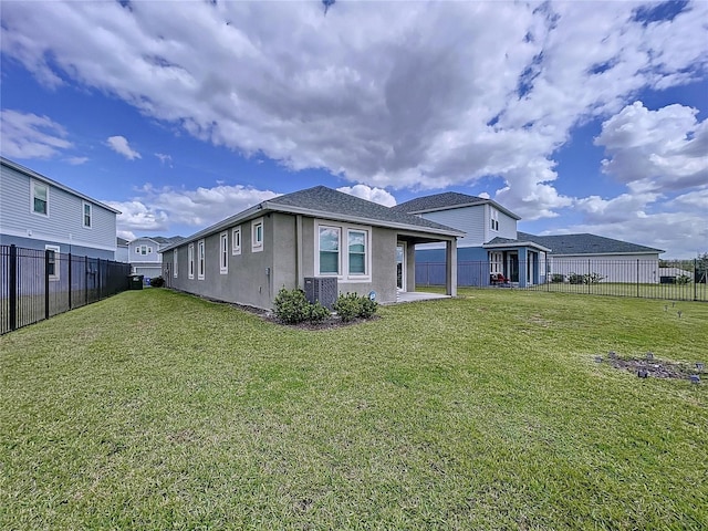 view of property exterior with an attached carport, a lawn, a fenced backyard, and stucco siding