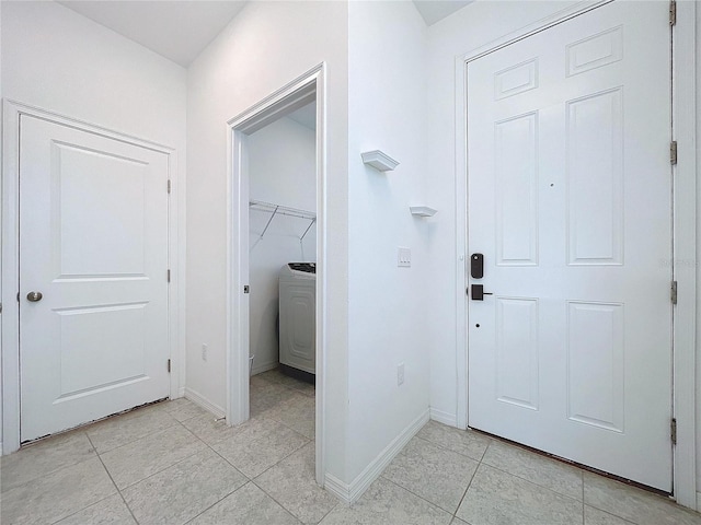 interior space featuring light tile patterned floors and baseboards