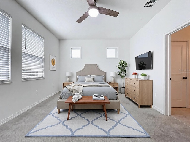 bedroom featuring light carpet, baseboards, visible vents, and ceiling fan