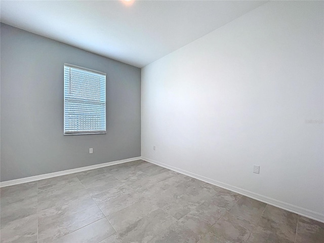 spare room featuring baseboards