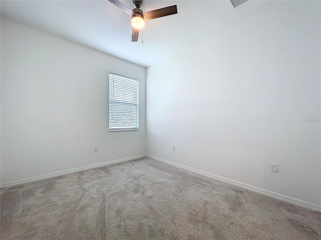 unfurnished room featuring carpet floors, baseboards, and a ceiling fan