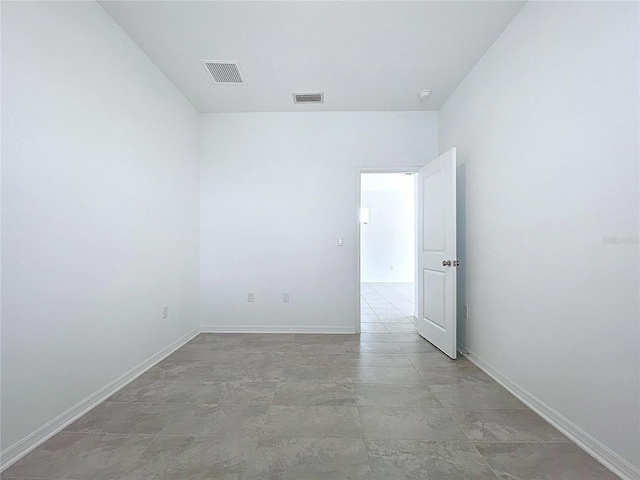 spare room with visible vents and baseboards