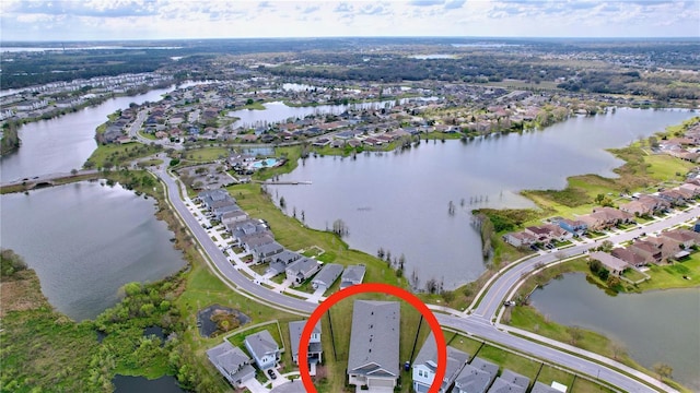 drone / aerial view with a water view and a residential view