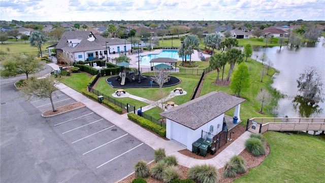 drone / aerial view featuring a water view and a residential view