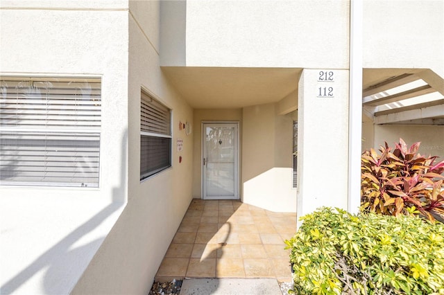 property entrance featuring stucco siding