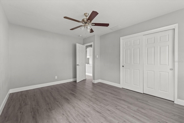 unfurnished bedroom featuring baseboards and wood finished floors