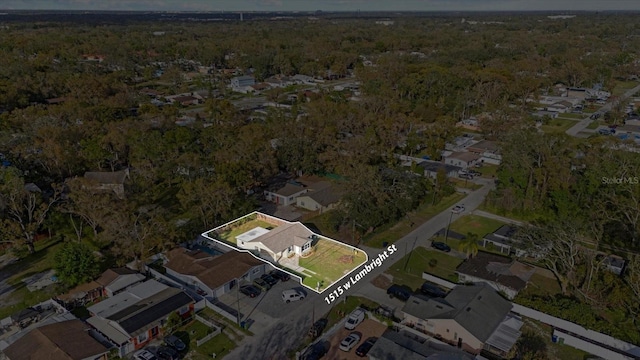 aerial view featuring a residential view and a wooded view