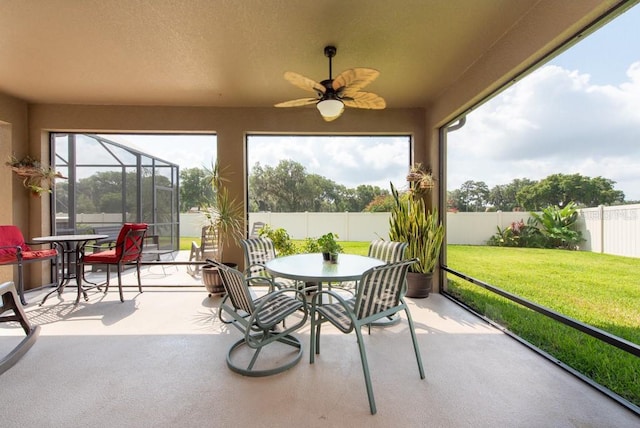 sunroom / solarium with a ceiling fan and plenty of natural light