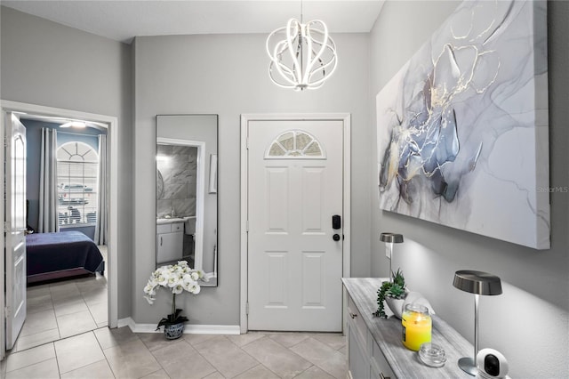 foyer with baseboards, light tile patterned flooring, and a notable chandelier