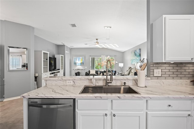 kitchen with a sink, visible vents, white cabinets, open floor plan, and dishwasher