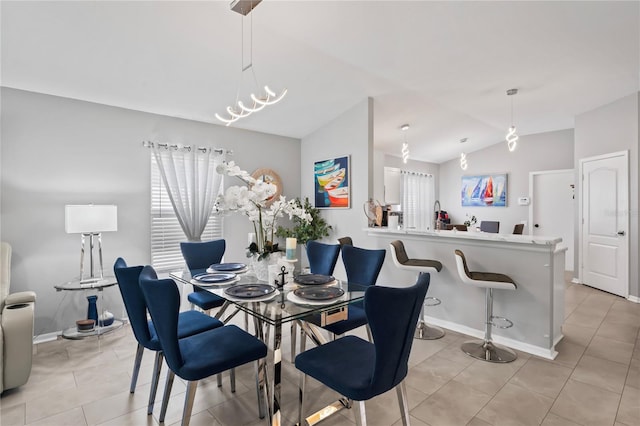 dining area featuring vaulted ceiling, light tile patterned floors, and baseboards