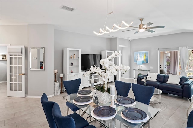 dining area with baseboards, visible vents, french doors, and ceiling fan with notable chandelier