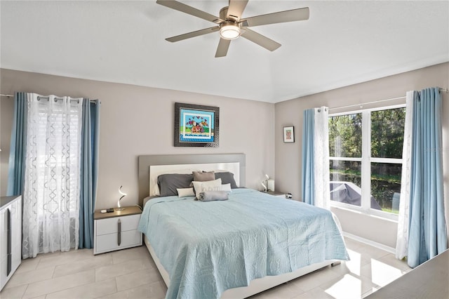 bedroom with a ceiling fan and light tile patterned floors