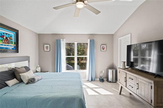 bedroom with a ceiling fan, lofted ceiling, and baseboards