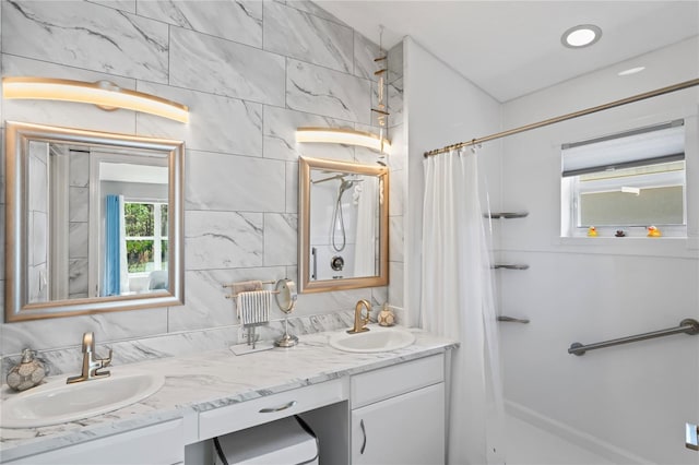 bathroom featuring double vanity, curtained shower, decorative backsplash, and a sink