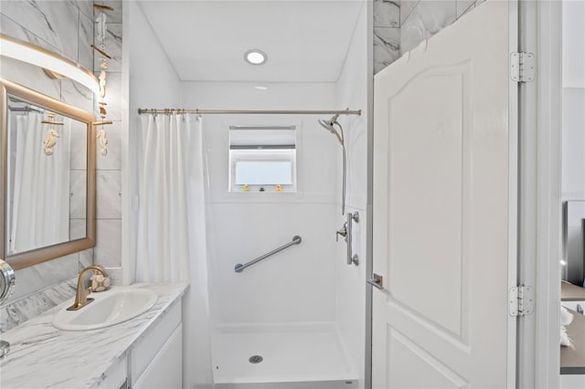 bathroom featuring curtained shower and vanity