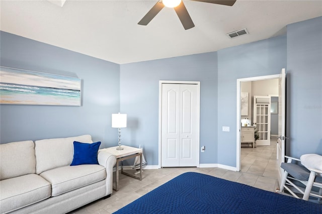 bedroom with light tile patterned floors, a closet, visible vents, a ceiling fan, and baseboards