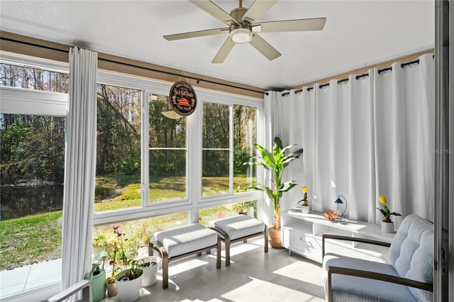 sunroom / solarium featuring ceiling fan