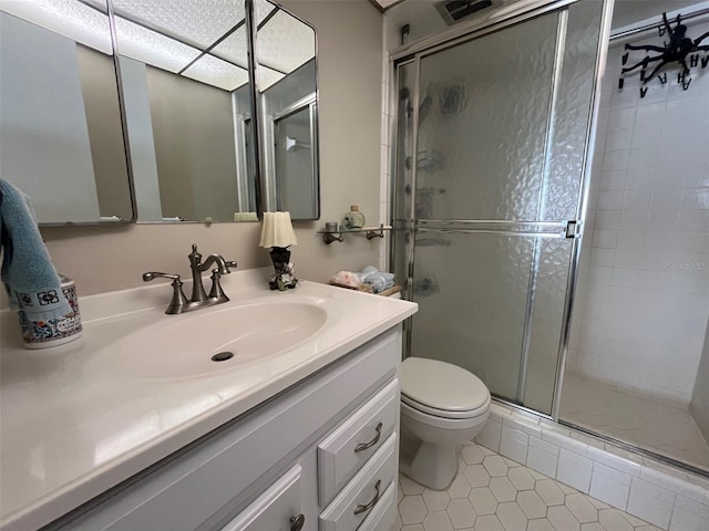 full bathroom with tile patterned flooring, toilet, a shower stall, and vanity